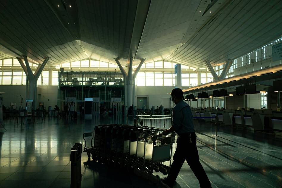 Stylish influencer carrying premium carry-on luggage at airport terminal